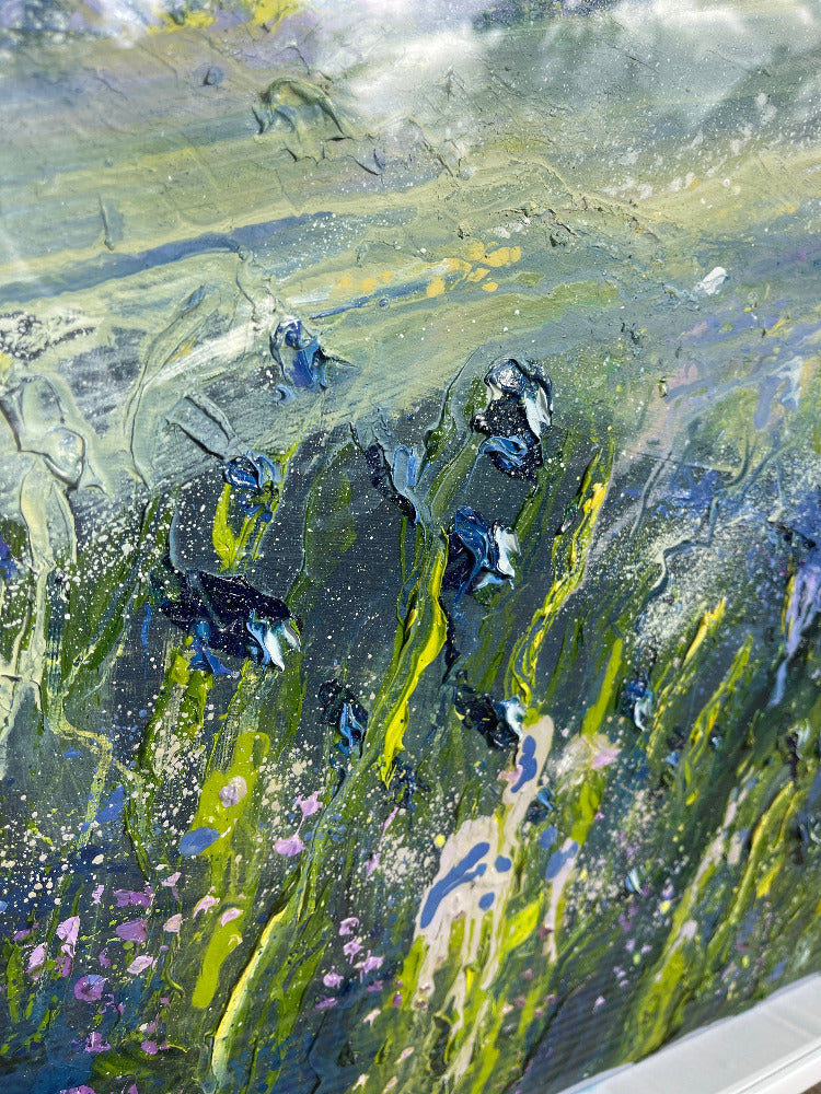 Abstract art with a mix of green, blue, and purple colors on a textured surface.