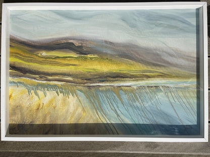 Framed abstract landscape painting on a wooden surface
