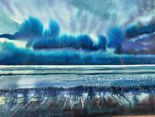 A watercolor painting depicting a stormy sea with dark clouds above and light reflecting off the wet sand.
